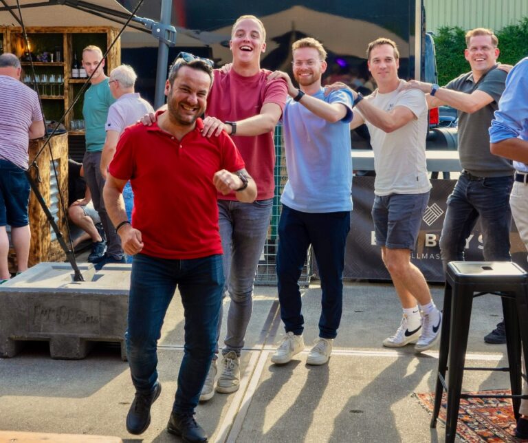 Collega's lopen in polonaise tijdens bedrijfsfeest.